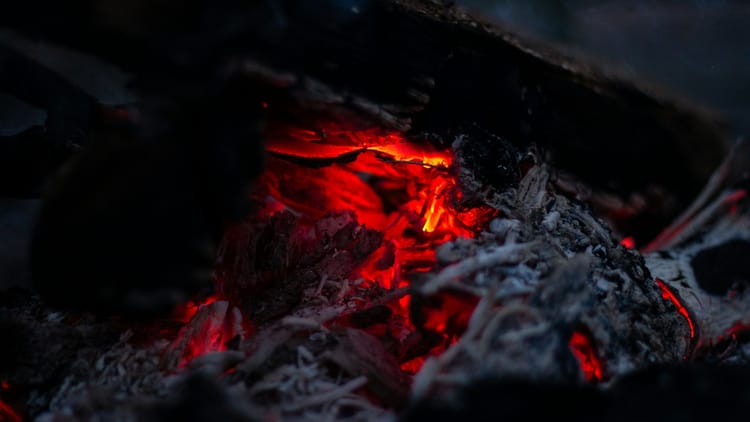 glowing embers in a pan or pot of some kind
