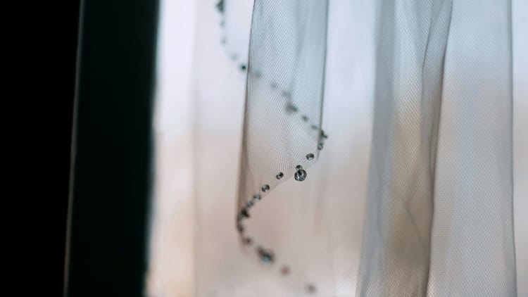 a very thin veil or curtain with a window behind it