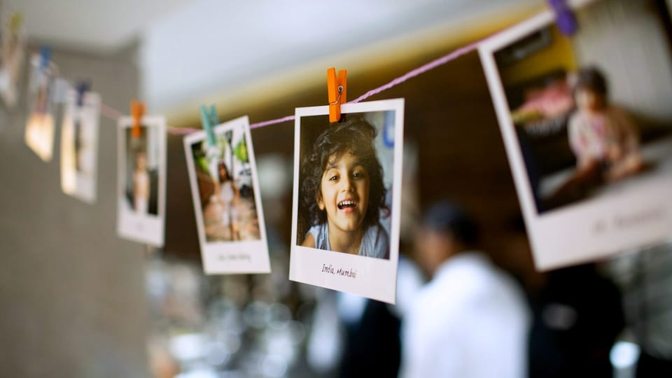 instant photos attached to a long string with tiny plastic clothespins