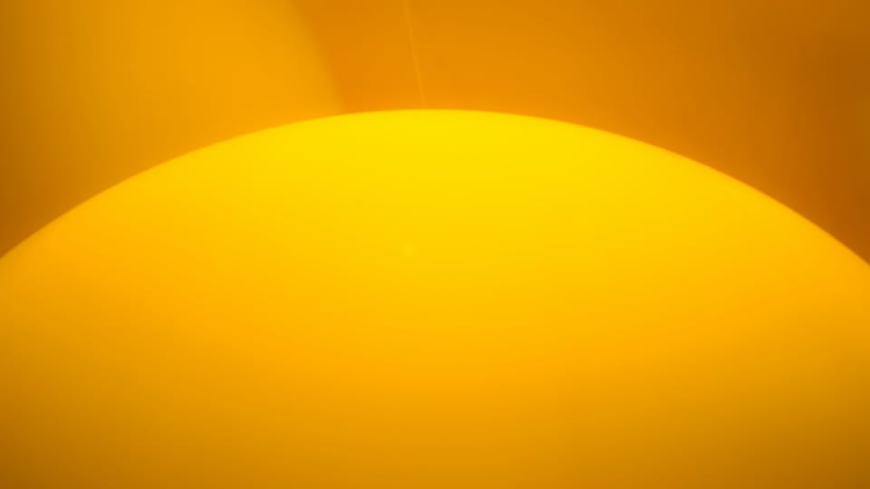 mostly yellow image of what might be the top portion of the sun